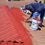 Professional roof painters preparing a house in Tweed Heads with thorough roof pressure cleaning Pottsville before applying coastal grade paint.
