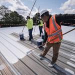 A professional roofing contractor applying a thick protective roof membrane coating to a residential home in Mullumbimby.